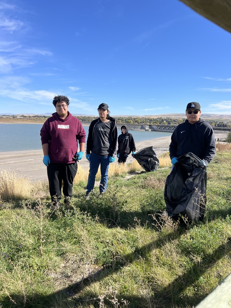 Students picking up  trash at the west boat dock