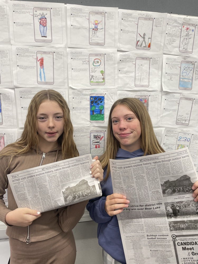 Claudia and Jordyn with their newspapers 