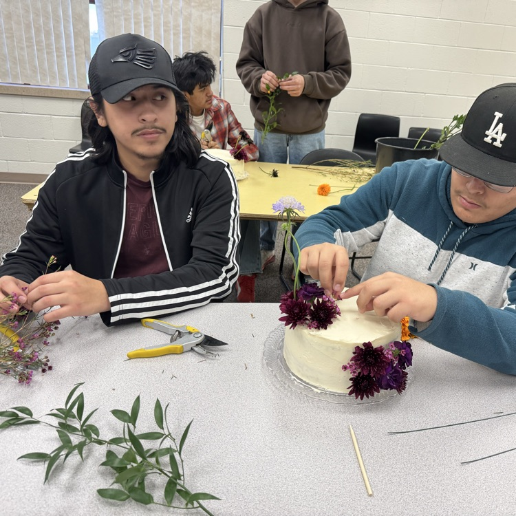 students designing cake with flowers