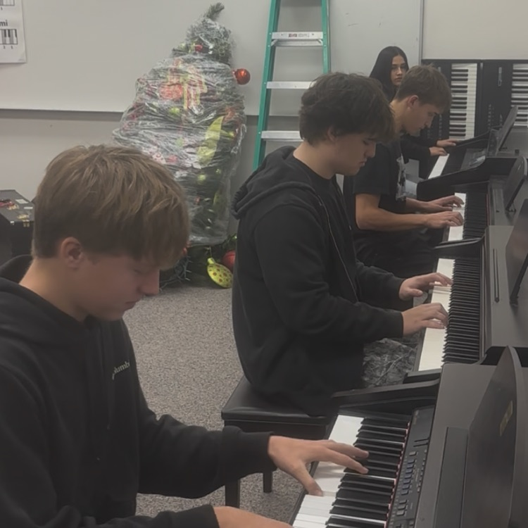 students in piano class
