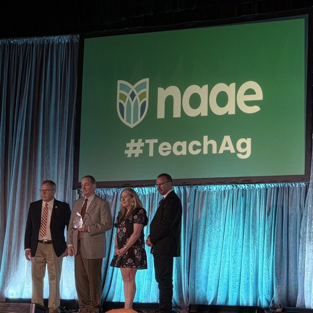 Mr. Beitia on stage receiving his award.