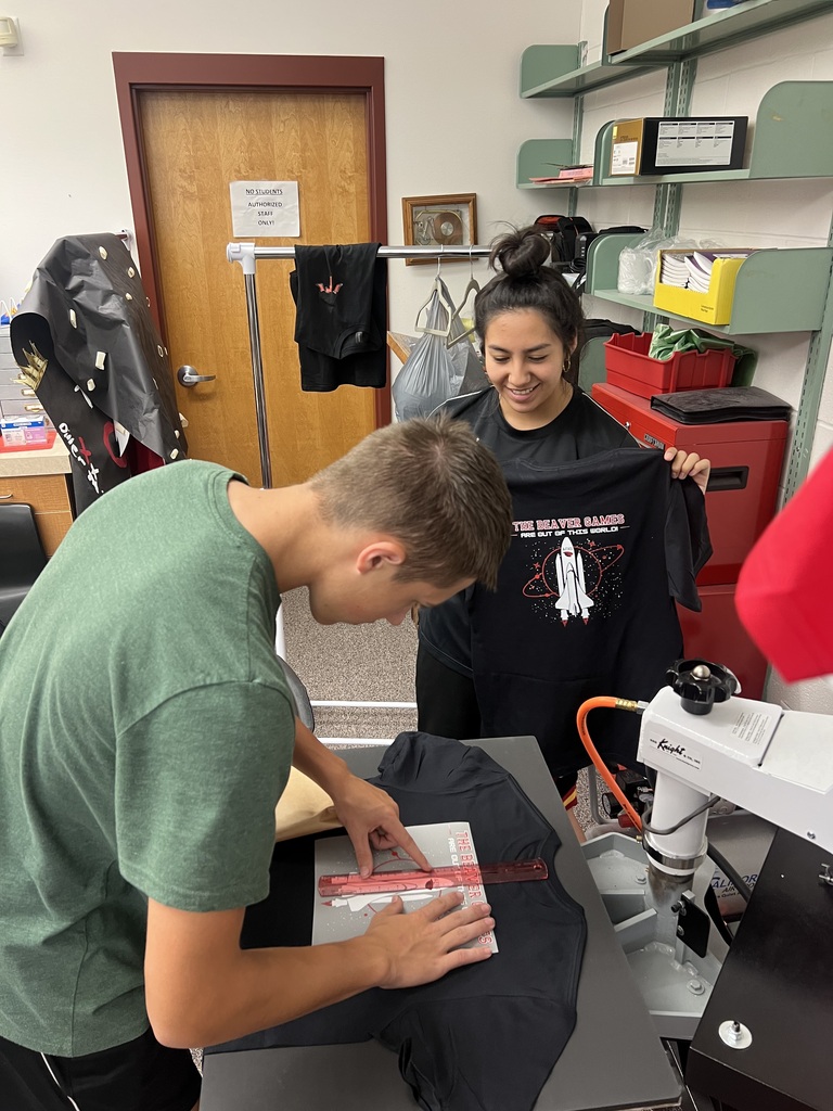 Blake S. and Valerie R. measure and press shirts for homecoming