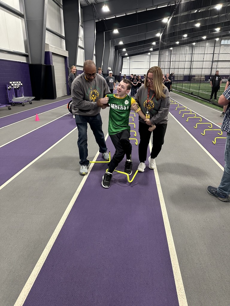 Amherst Special Olympics student participates in a skills challenge with the help of staff at Ashland University for a soccer training 