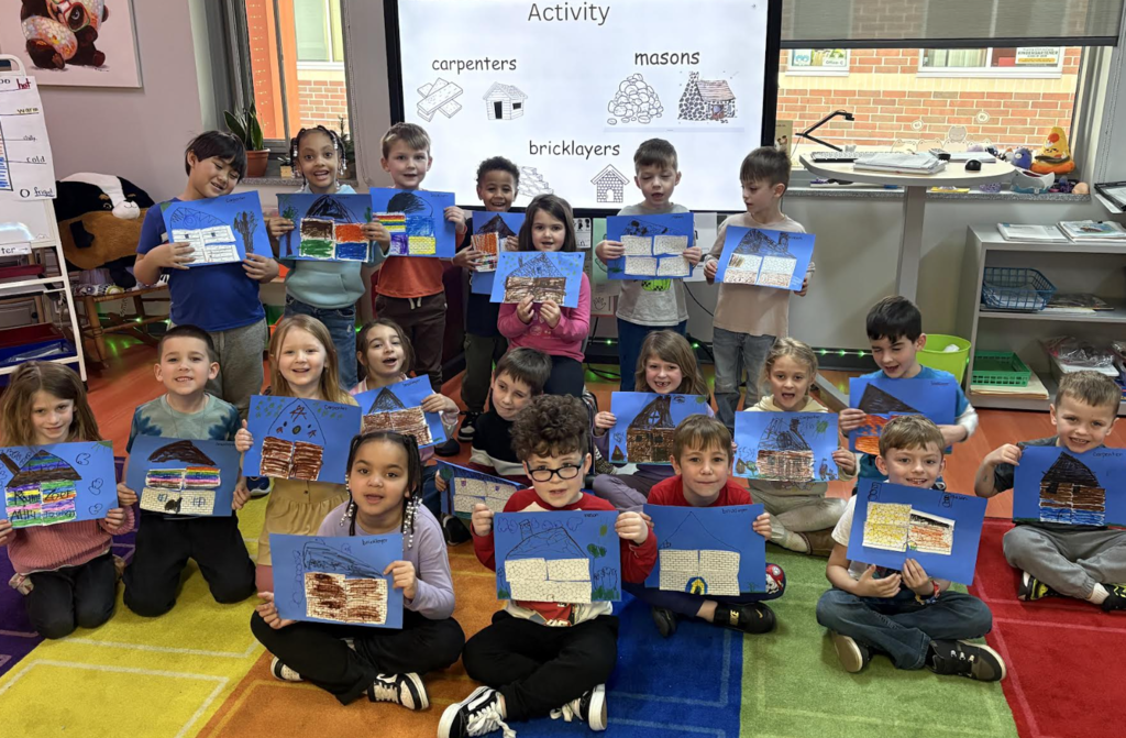 picture of whole class with pictures demonstrating house building skills