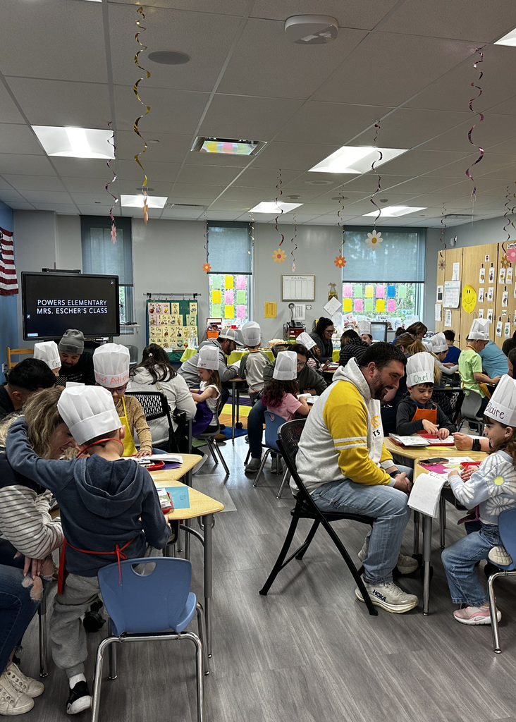 group shot of the Reading Cafe in Mrs. Escher's Kindergarten Class - parents reading with their students in chef hats