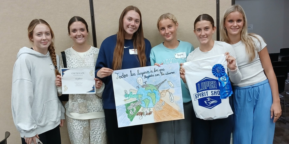 Spanish III students holding up 1st place poster at UNK Foreign Language Day