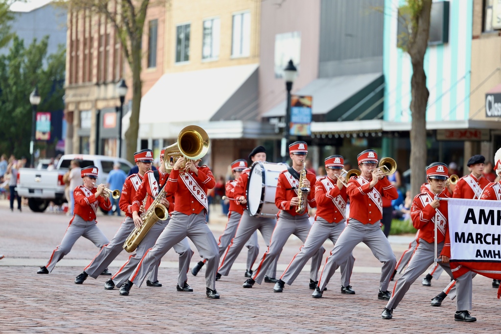The Amherst band marches down a street.