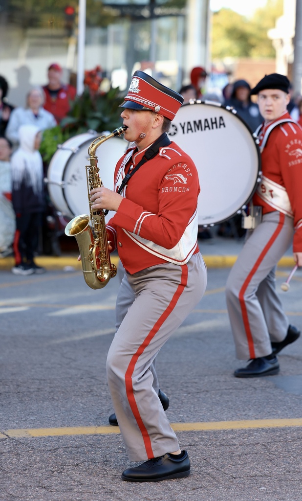 Amherst band saxophone player performs on a city Street