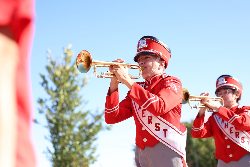 Amherst trumpet player marches down city street