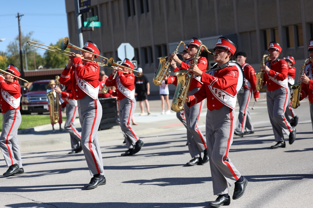 Amherst Band marches down city street (horns)