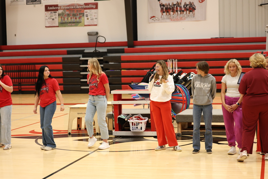 A coach speaks at a pep rally