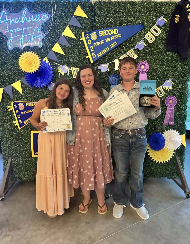 Students with Mrs. Lane holding rewards from the Junior FFA banquet