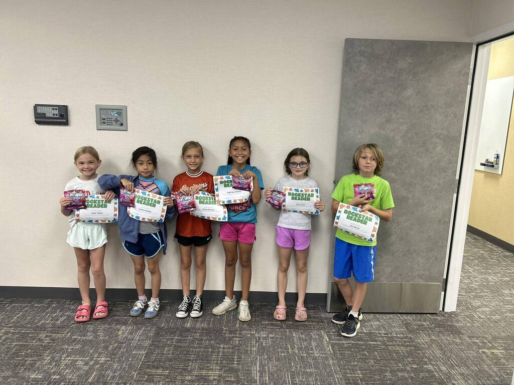 Kids holding awards.