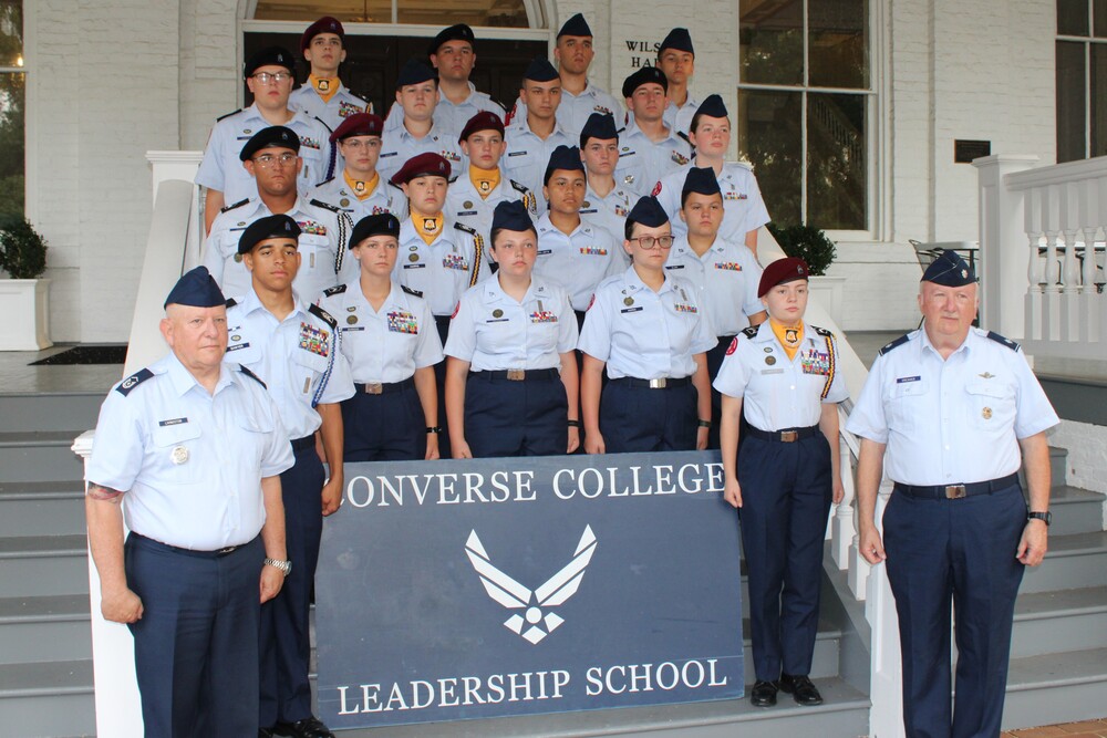 AFJROTC Cadets posing for a group photo with a sign that says Converse College Leadership School