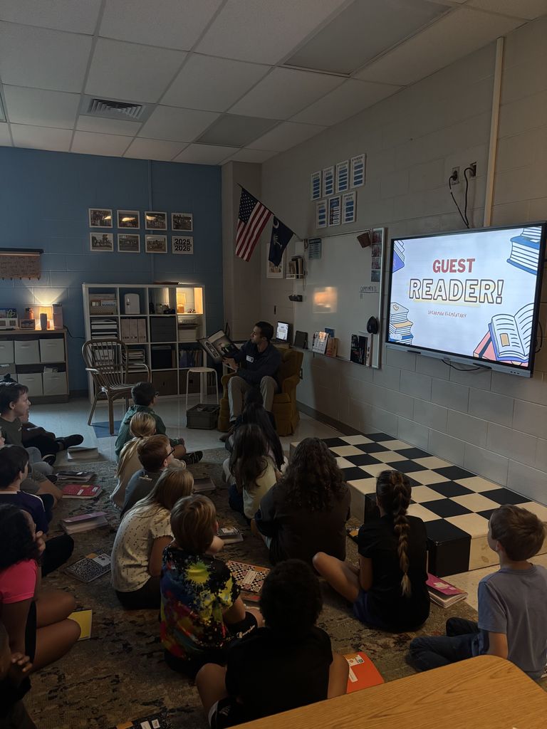 Mr. Stewart reading to Mrs. Stewart's 4th grade class