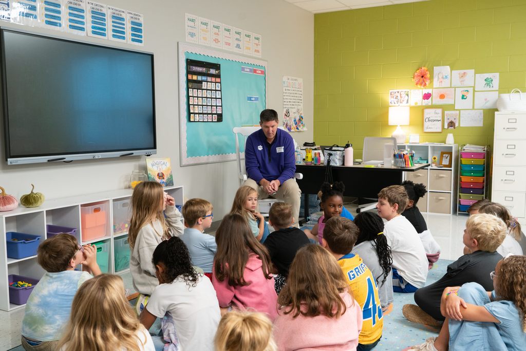 Coach Brownell reading to Mrs. Brownell's 3rd grade class