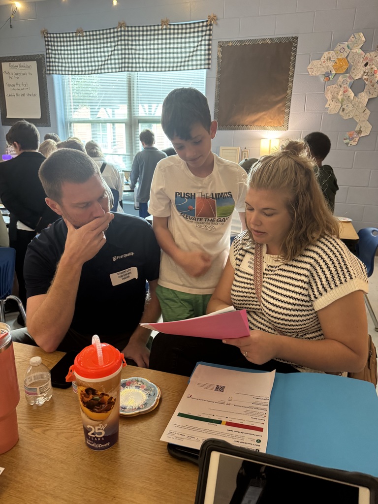 4th Grade Student Led Conference - Mom, dad and son