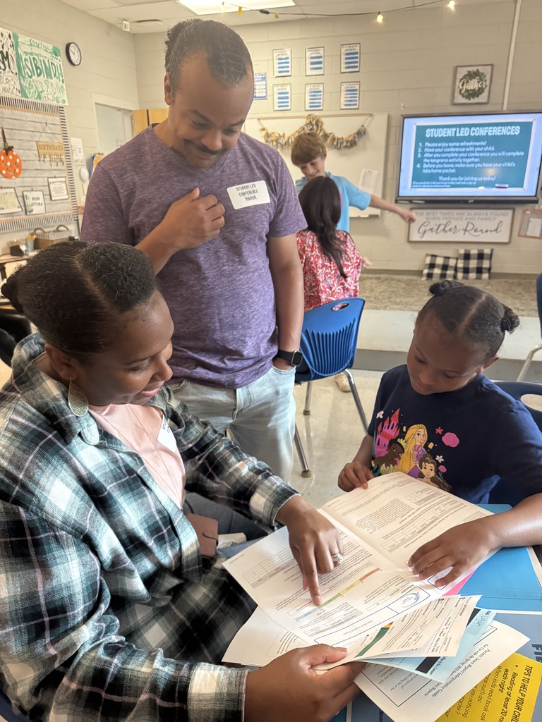 4th Grade Student Led Conference Phillips Class - Daughter with mom and dad