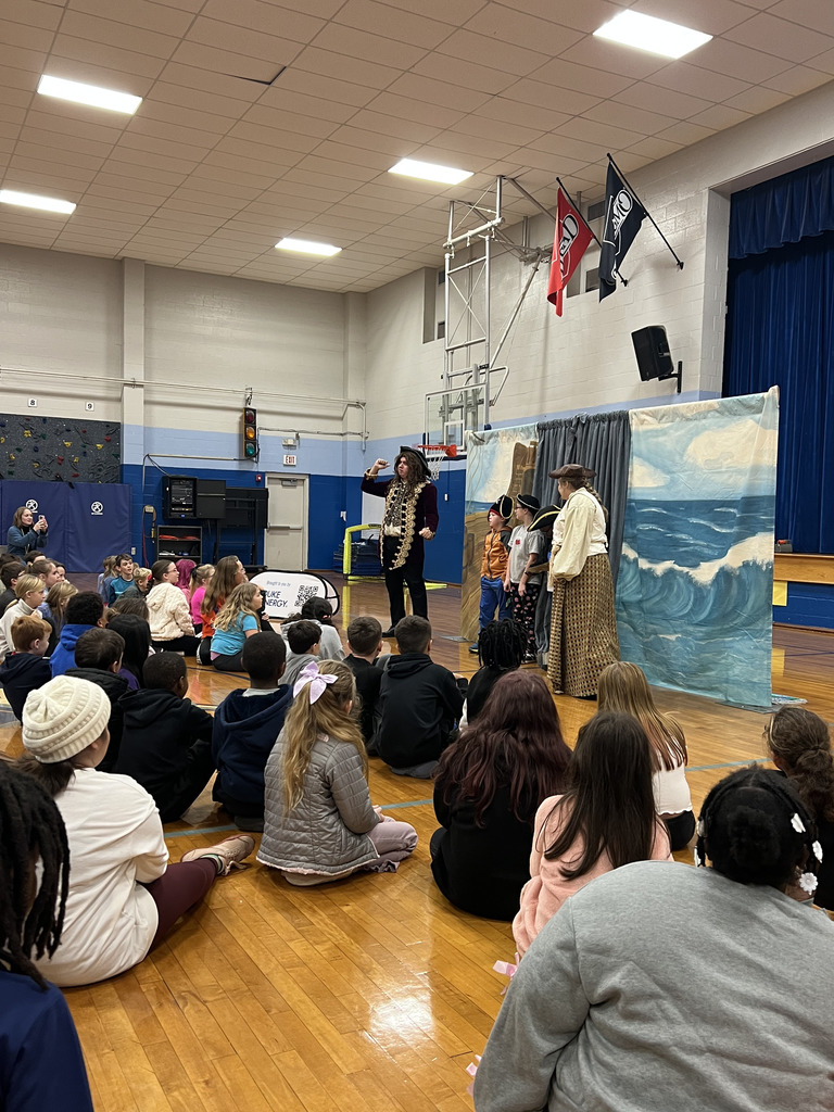 students engaged in presentation and 3 students with actors acting out skits