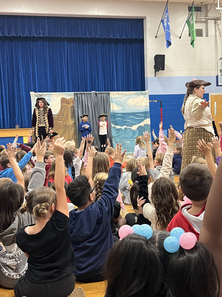 students raising hand and 2 students with actors acting out skits