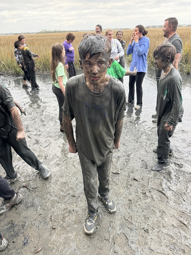 5th Grade Student covered in mud from mud pit