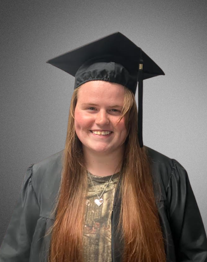 a student posing for a picture in graduation cap and gown