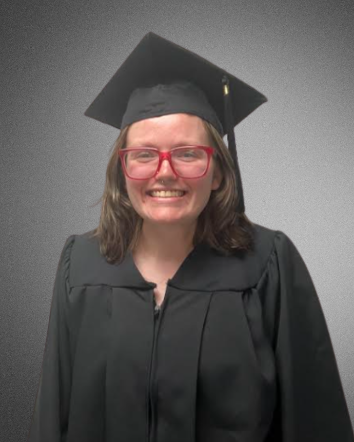 a student posing for a picture in graduation cap and gown