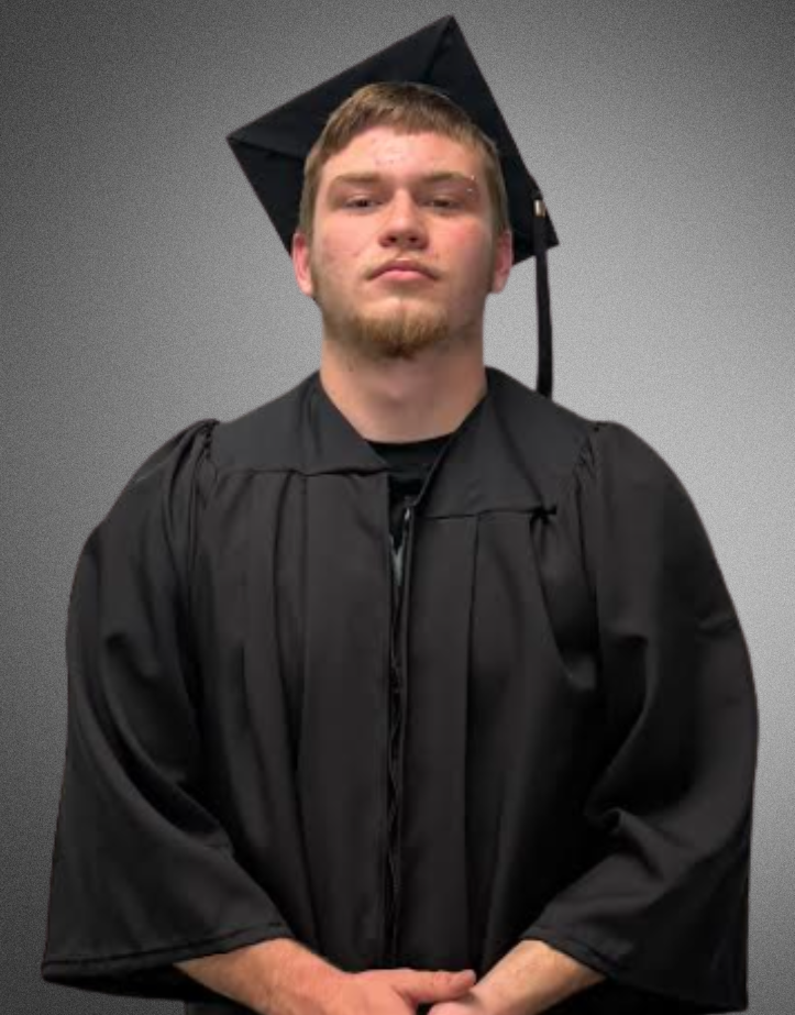 a student posing for a picture in graduation cap and gown