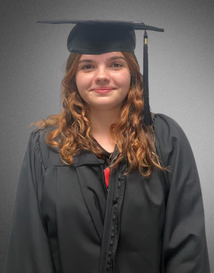 a student posing for a picture in graduation cap and gown