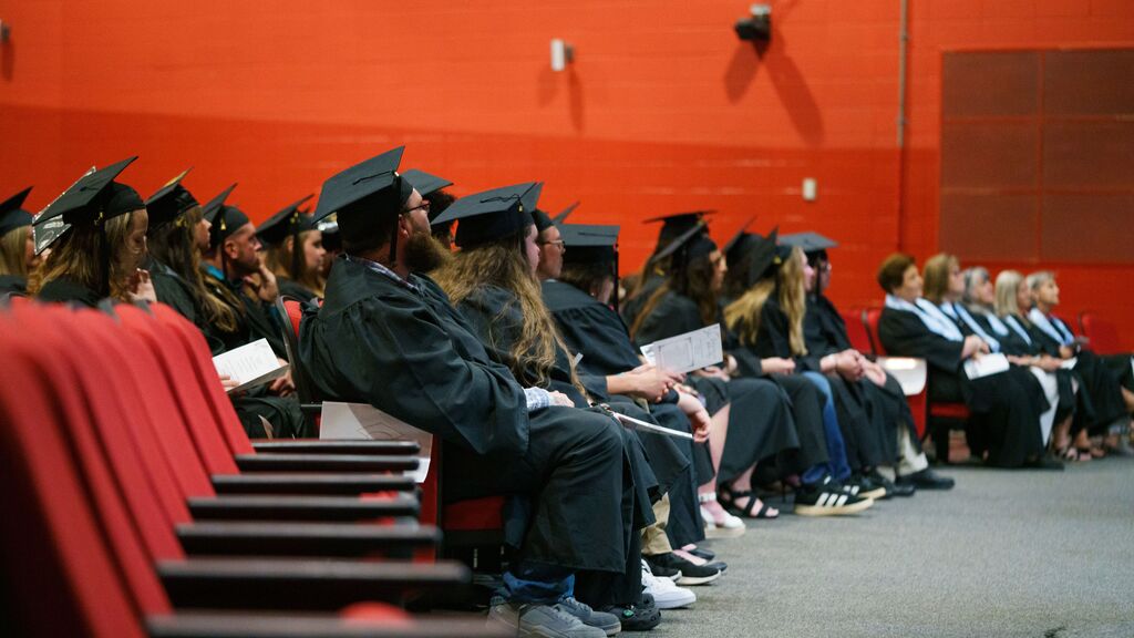 graduates sitting in their seats listening to the speackers