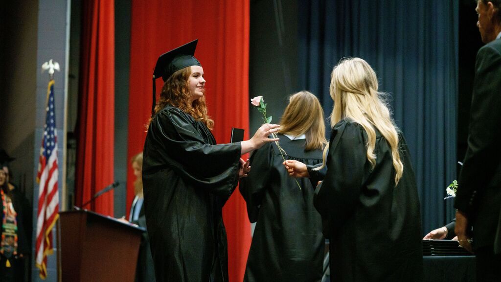 student receiving rose