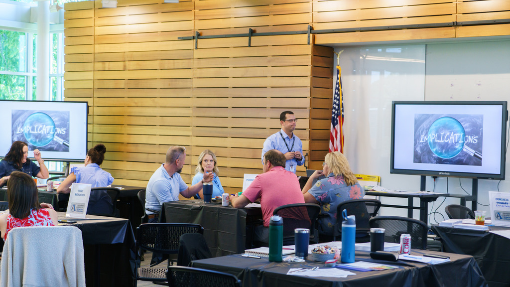 Staff members collaborate and map out their vision for the upcoming school year by talking together at a table