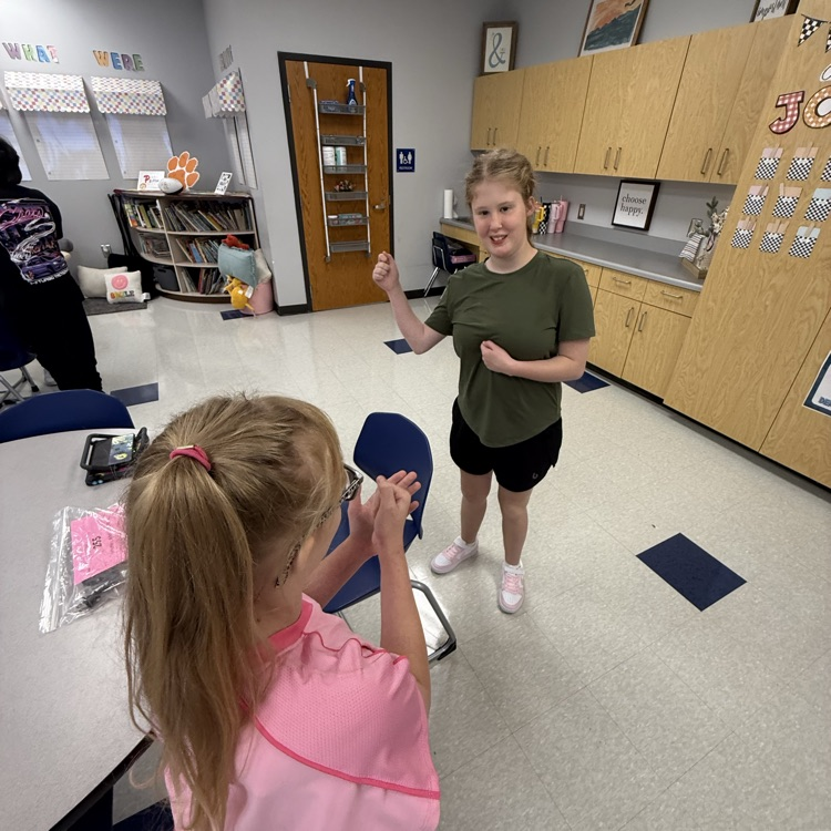 more students playing rock paper scissors