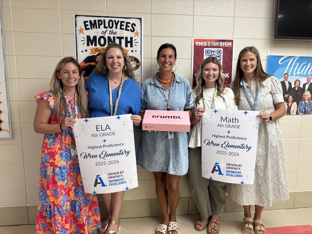 Fourth grade teacher receiving their top performer posters