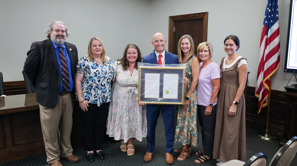 Representative Chris Huff poses for a photo with staff and family after presenting Palmetto Middle School with a proclamation for its suicide awareness initiative