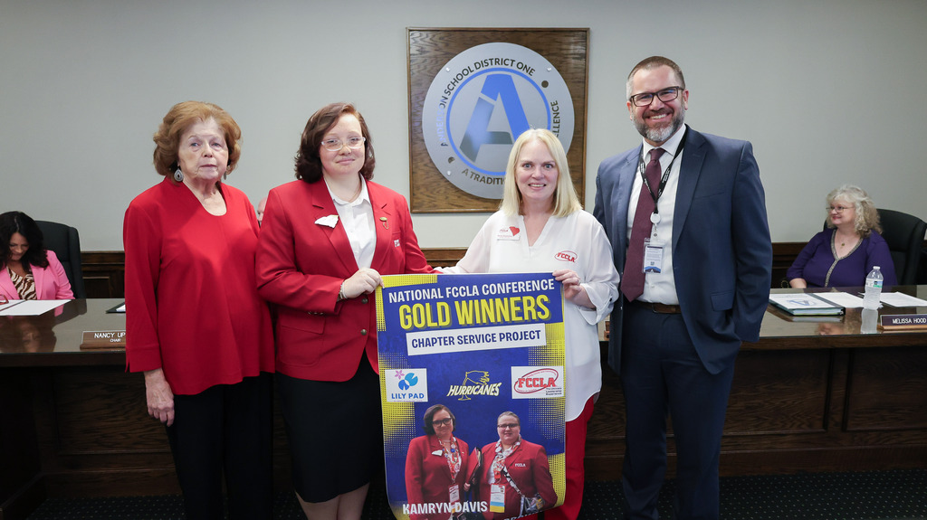 the board chair and superintendent pose for a picture with students recognized for receiving a national FCCLA Conference award