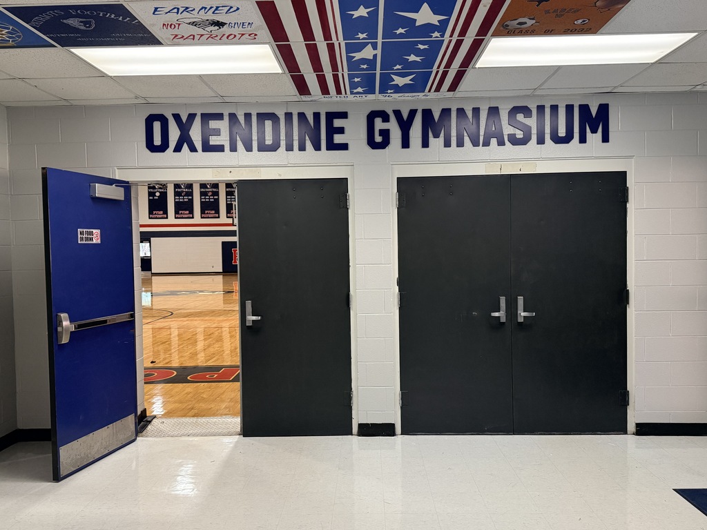 The gymnasium doors with the new name 'Oxendine Gymnasium' above the doors