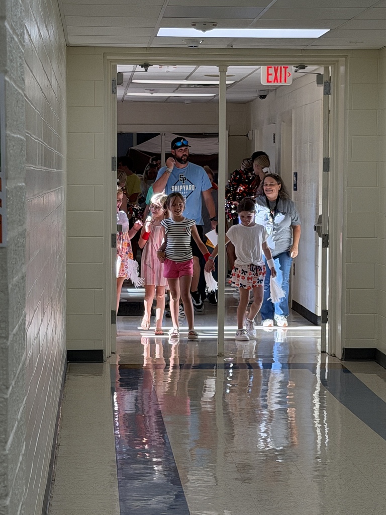 Students, staff, and family members walk through the hall during curriculum night