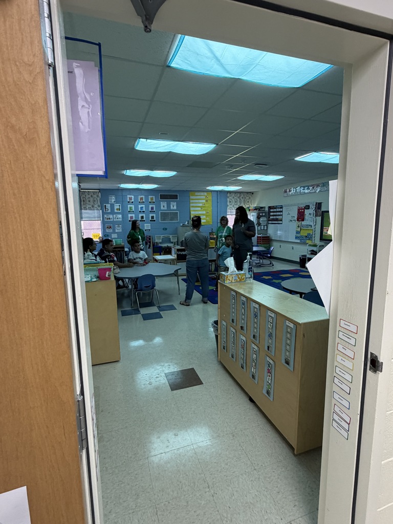 Students, staff, and family in a classroom during curriculum night