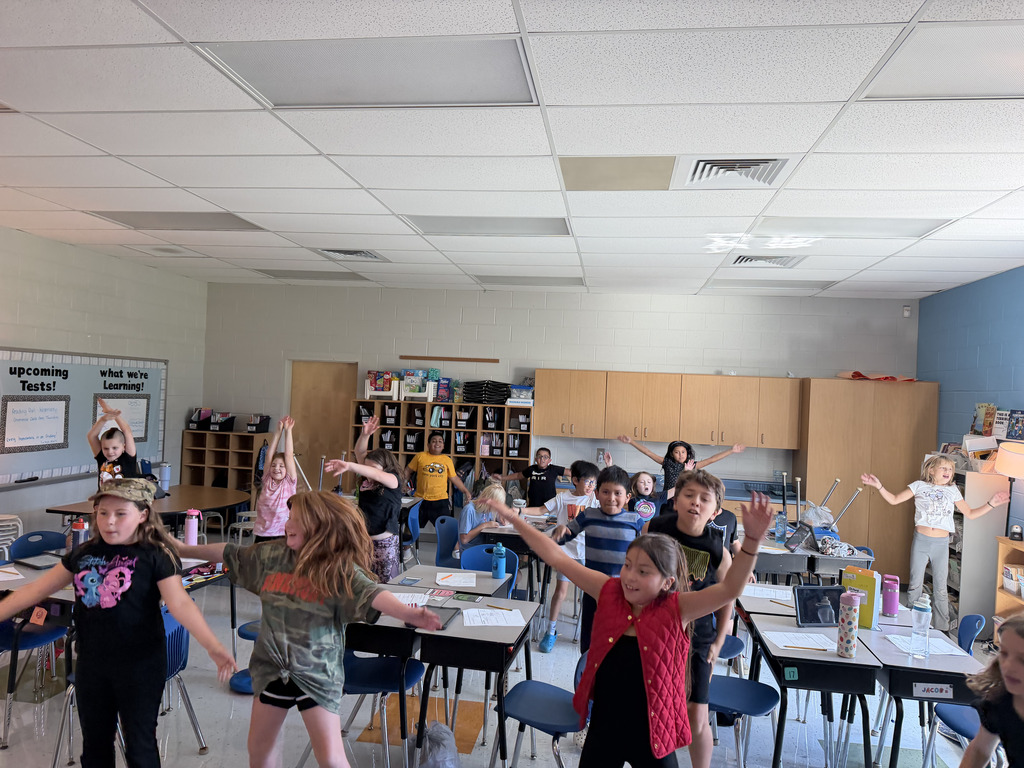 Students stretch and move around the classroom during an active learning break.