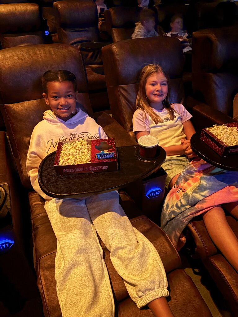 2 girls hanging out at the movie tiger rising with popcorn and their drink