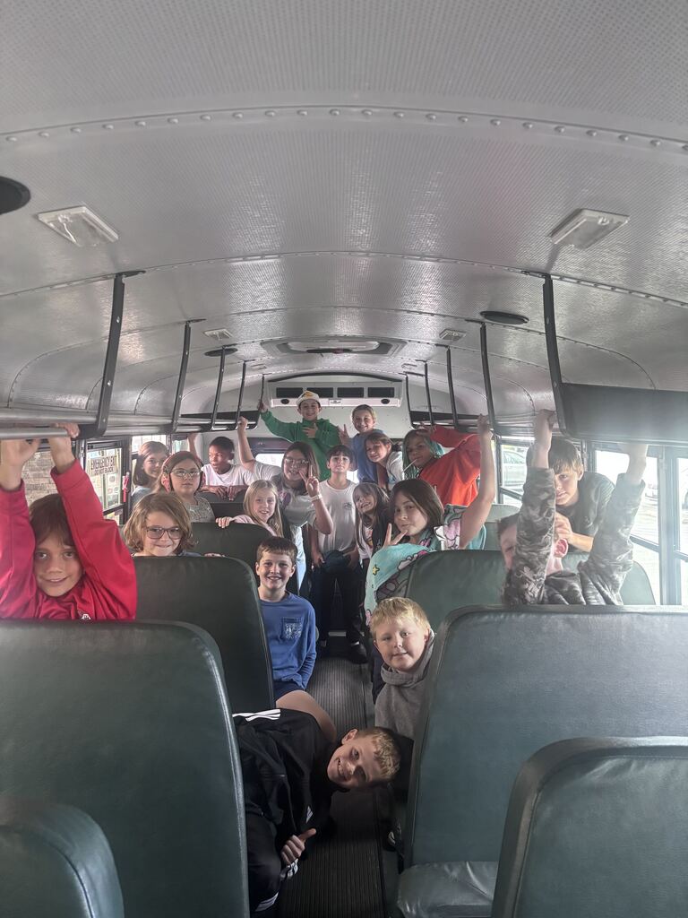 a group of 4th graders on the bus ride