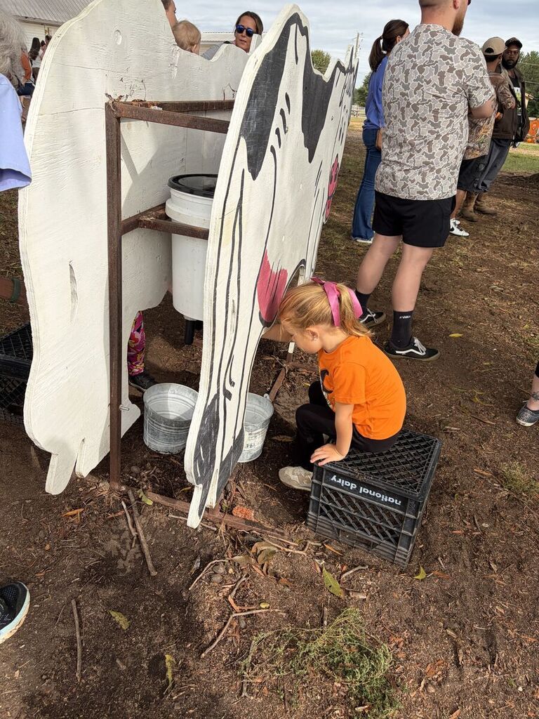 K4 student milking the wooden cow