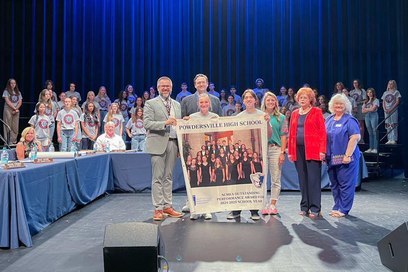 Powdersville High School chorus program was recognized for receiving the SCMEA Outstanding Performance Award. They posed with school board members and the superintendent.