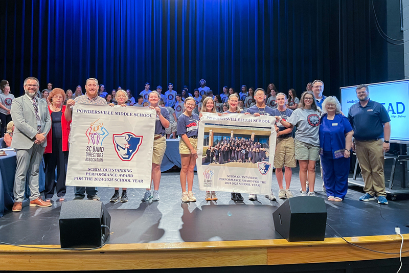 The Powdersville High and Middle School band programs were recognized for receiving outstanding performance awards from SCBDA. They posed with school board members and the superintendent