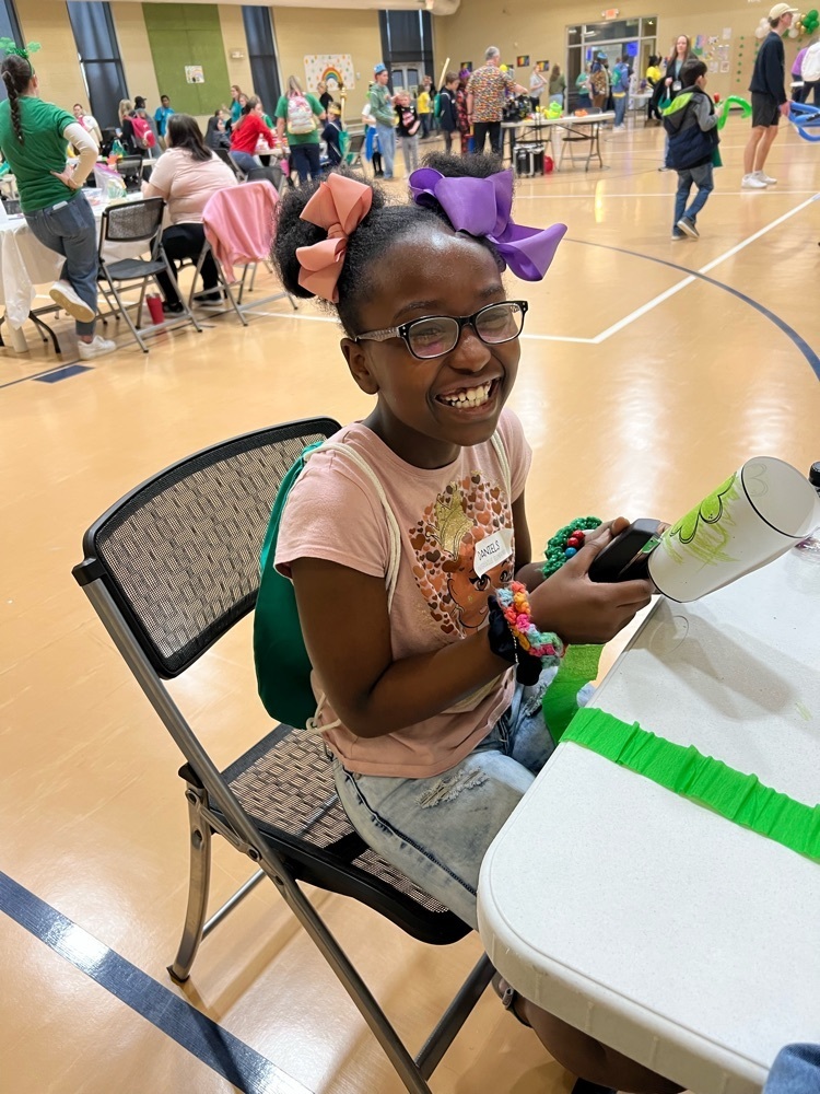 student smiling while doing art