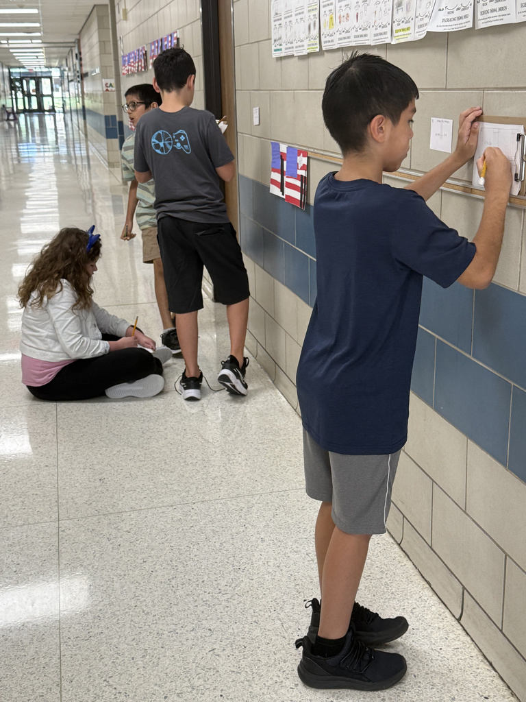 Who says math review can't be an adventure? Our 5th graders took their learning to the hallway for a gallery walk, working through task cards posted on the walls. This innovative method keeps students active and excited about reinforcing their math skills. It's awesome to see them so focused and ready to learn!