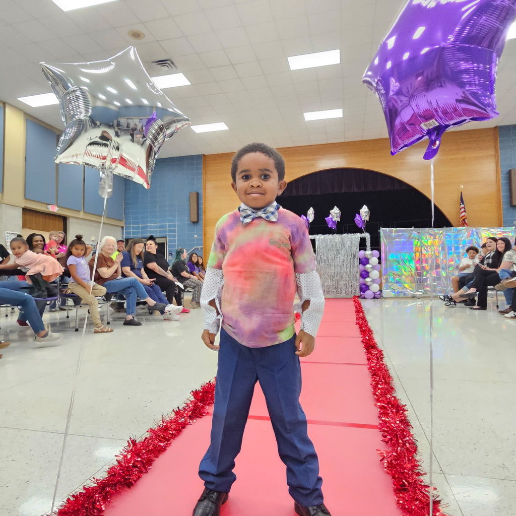 Learning comes to life in Pre-K! Their recent Clothing Unit culminated in a fabulous Fashion Show, reinforcing everything from sorting by color and texture to developing essential self-help skills like buttoning and zipping.  Our students got to put their vocabulary and classification skills into action as they became designers and models for the day. A huge shoutout to our students for their creativity and our amazing teachers for making learning so tangible!