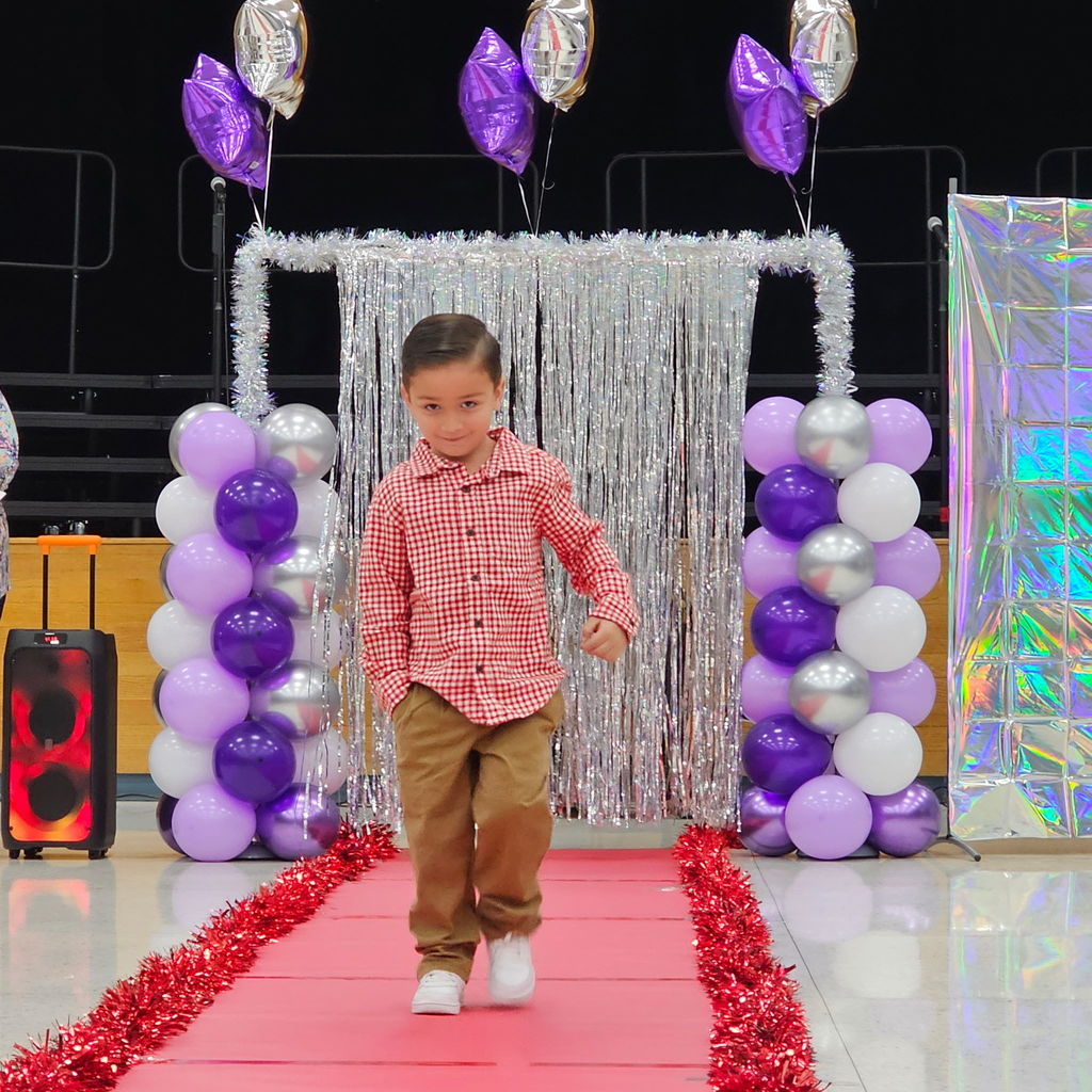 Learning comes to life in Pre-K! Their recent Clothing Unit culminated in a fabulous Fashion Show, reinforcing everything from sorting by color and texture to developing essential self-help skills like buttoning and zipping.  Our students got to put their vocabulary and classification skills into action as they became designers and models for the day. A huge shoutout to our students for their creativity and our amazing teachers for making learning so tangible!