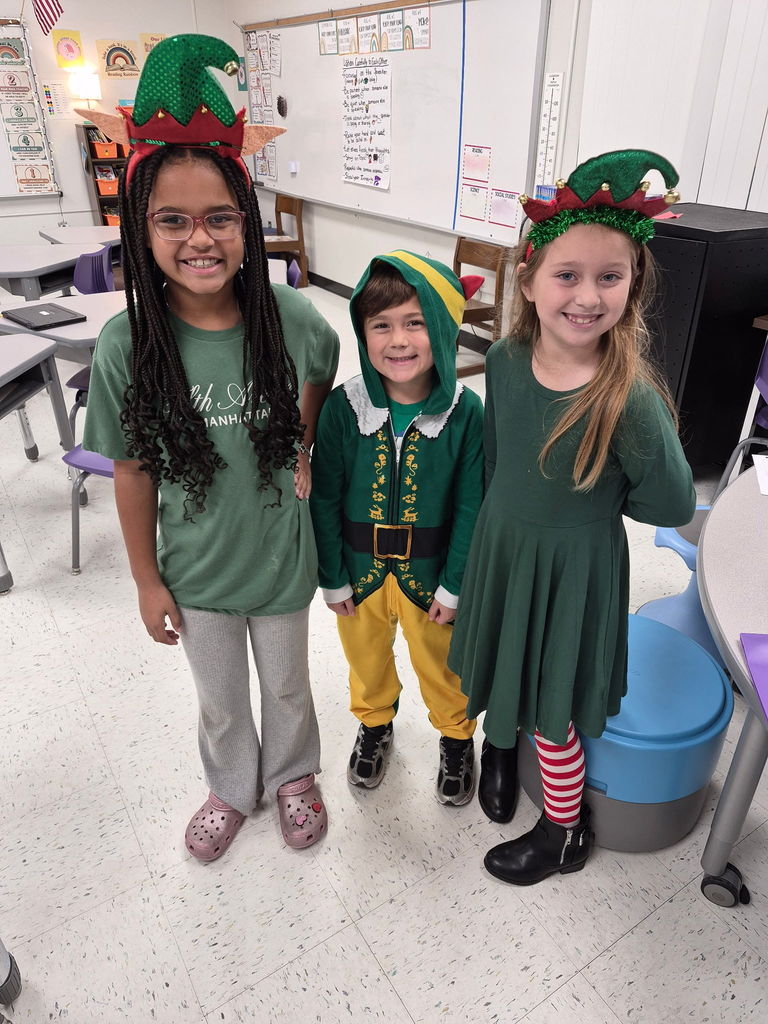 "Selfie with an Elfie! Our halls are officially under elf surveillance today! From sparkly sequins to striped socks, our students and staff definitely understood the assignment. We love seeing so much creativity and joy walking through the school!  Reminder: Don't forget that tomorrow is Rudolph/Reindeer Day!